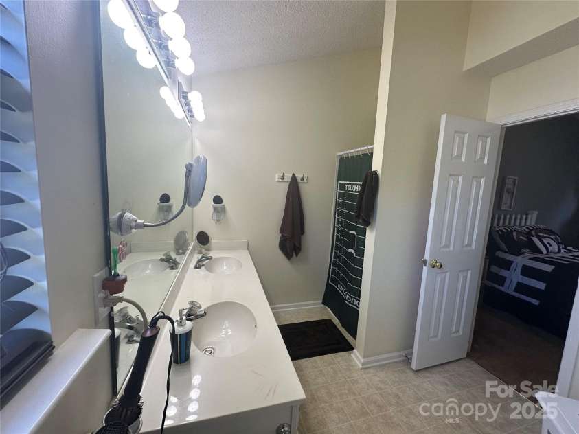 5845 Mahogany Place, Concord, NC 28025.  MLS# CAR4283667, YatesRealty ID 30850. Primary bathroom with dual vanity and separate garden tub and shower