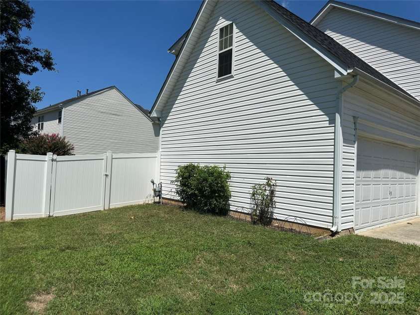 5845 Mahogany Place, Concord, NC 28025.  MLS# CAR4283667, YatesRealty ID 30850. Side yard with large gate