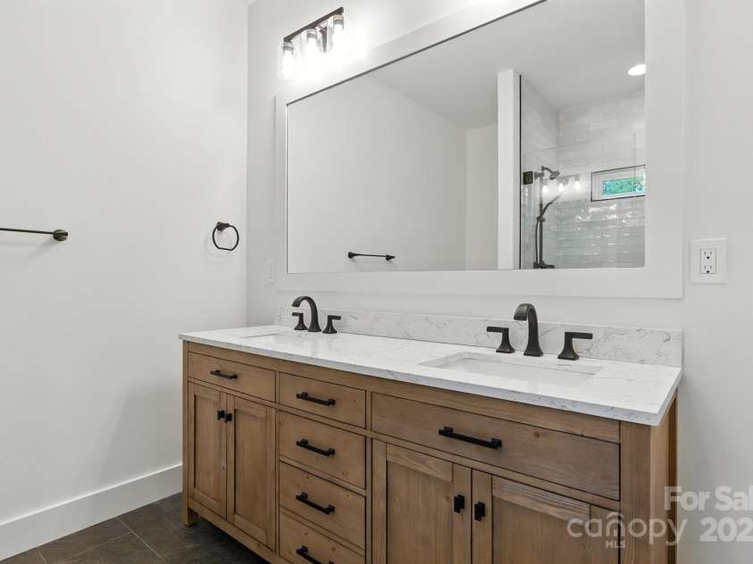 82 Lillycrop Lane, Hendersonville, NC 28792.  MLS# CAR4273359, YatesRealty ID 30864. Large double sink in primary bathroom