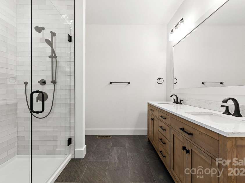 82 Lillycrop Lane, Hendersonville, NC 28792.  MLS# CAR4273359, YatesRealty ID 30864. Primary bathroom includes gorgeous double sink and large tile shower