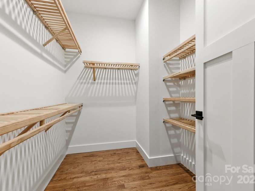 82 Lillycrop Lane, Hendersonville, NC 28792.  MLS# CAR4273359, YatesRealty ID 30864. Walk-in closet with wood shelving provides abundant storage