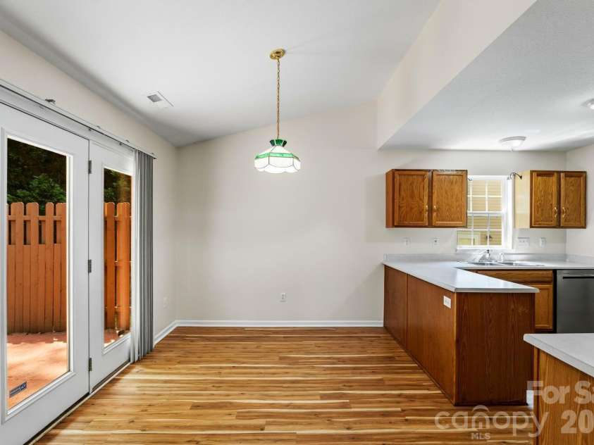 308 Wiltshire Circle, Fletcher, NC 28732.  MLS# CAR4389332, YatesRealty ID 30869. Dining area. French doors on left lead to patio.