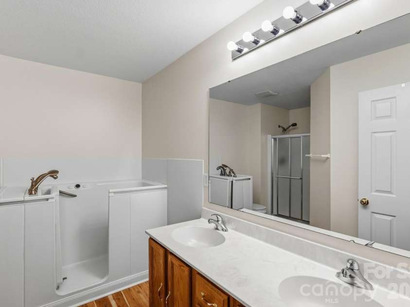 308 Wiltshire Circle, Fletcher, NC 28732.  MLS# CAR4389332, YatesRealty ID 30869. Primary bath with large vanity, shower, and accessible tub.