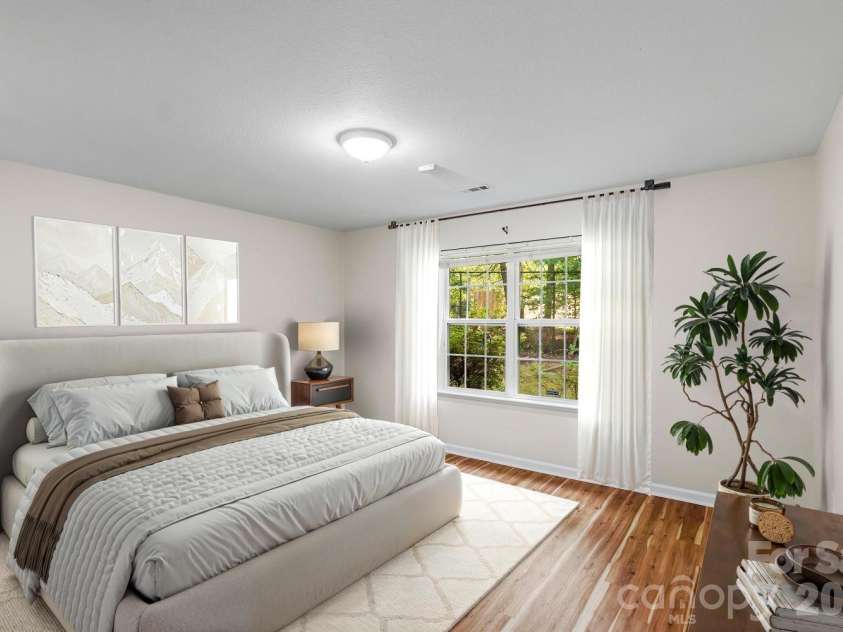 308 Wiltshire Circle, Fletcher, NC 28732.  MLS# CAR4389332, YatesRealty ID 30869. Spacious primary bedroom overlooks back yard (image has been virtually staged).