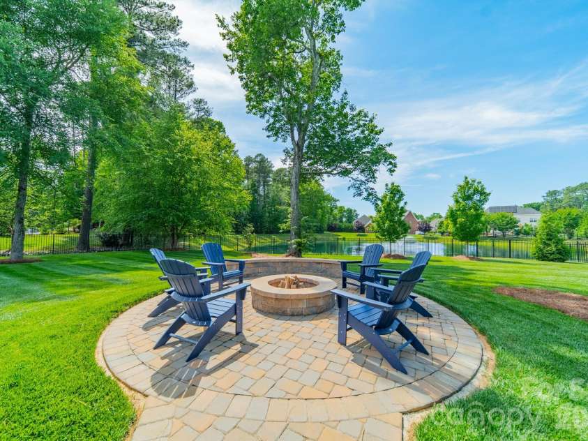 701 Copper Tree Lane, Waxhaw, NC 28173.  MLS# CAR4378056, YatesRealty ID 30870. Firepit gathering space with pavers and iluminated walkway