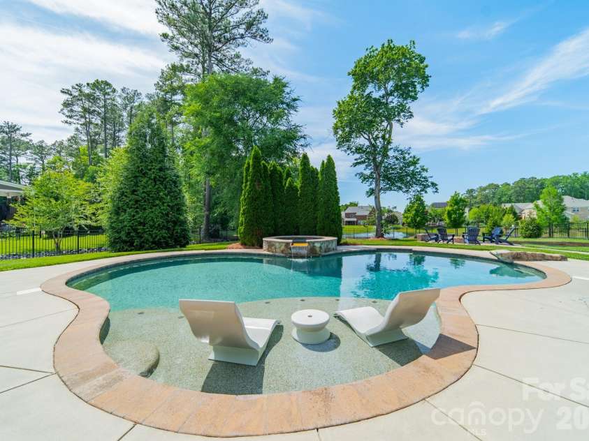 701 Copper Tree Lane, Waxhaw, NC 28173.  MLS# CAR4378056, YatesRealty ID 30870. Resort-style pool and spa, with a tanning ledge and a diving rock