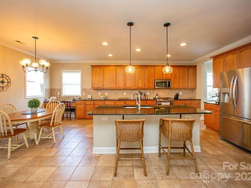 3015 Semmes Lane, Indian Trail, NC 28079.  MLS# CAR4284326, YatesRealty ID 30875. Yes, that's 30-foot by 13 1/2-foot kitchen with custom cabinets and granite countertops.