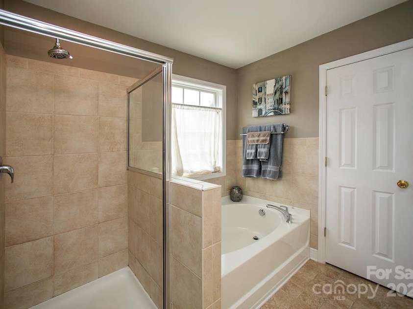 3015 Semmes Lane, Indian Trail, NC 28079.  MLS# CAR4284326, YatesRealty ID 30875. Your new walk-in shower and garden tub in the owners' suite.