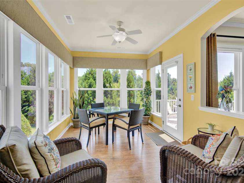 7028 Kitty Hawk Lane, Fort Mill, SC 29707.  MLS# CAR4285011, YatesRealty ID 30903. Light filled Sun Room with windows all around. Outside entry to deck.