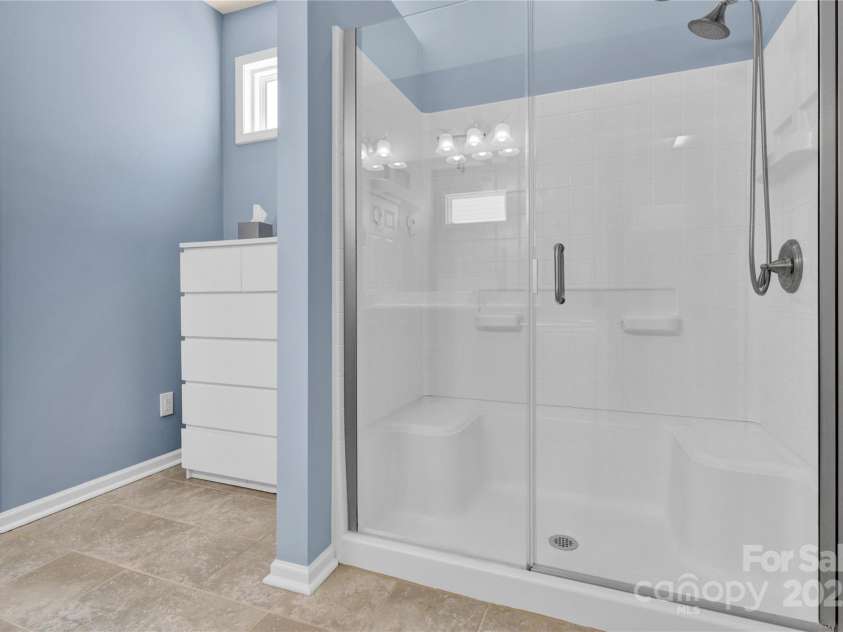 7028 Kitty Hawk Lane, Fort Mill, SC 29707.  MLS# CAR4285011, YatesRealty ID 30903. Primary Bath with walk-in shower with bench.
