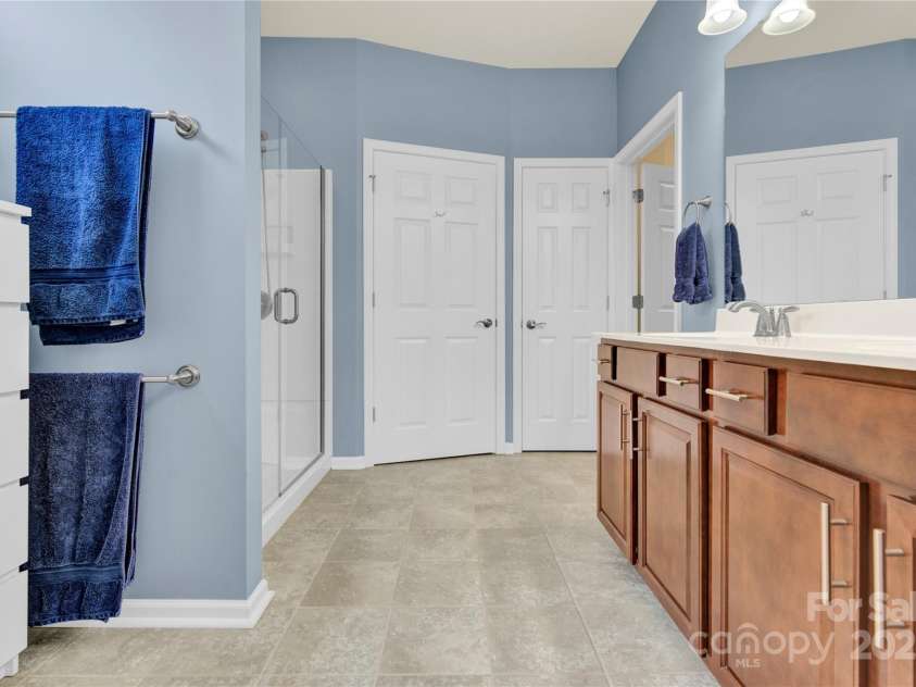 7028 Kitty Hawk Lane, Fort Mill, SC 29707.  MLS# CAR4285011, YatesRealty ID 30903. Spacious Primary Bath with double vanities, slow close drawers, and additional electrical outlets.