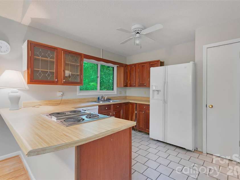 56 Guque Court, Brevard, NC 28712.  MLS# CAR4391612, YatesRealty ID 30909. Kitchen includes a pantry.