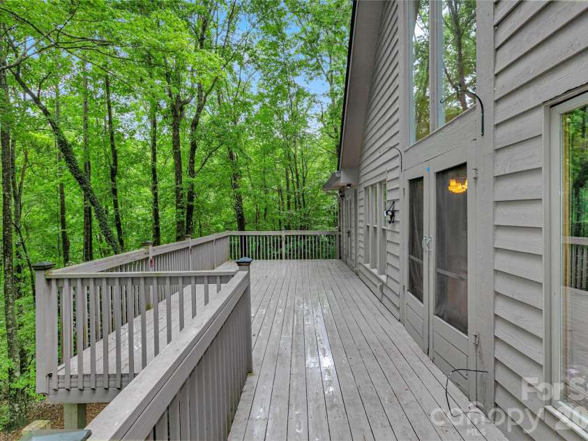 56 Guque Court, Brevard, NC 28712.  MLS# CAR4391612, YatesRealty ID 30909. Large Deck for entertaining.