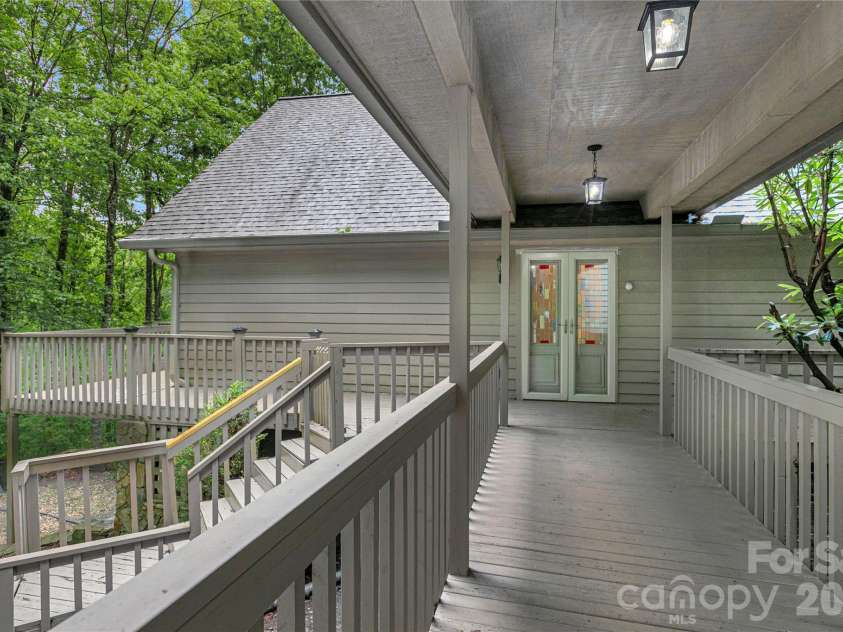 56 Guque Court, Brevard, NC 28712.  MLS# CAR4391612, YatesRealty ID 30909. Walkway to the front door. Note: NO STEPS!!