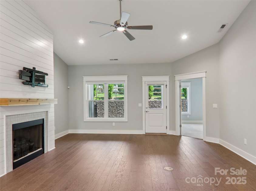 23 Cozy Cottage Way, Arden, NC 28704.  MLS# CAR4276854, YatesRealty ID 30919. Living area opens to covered back porch