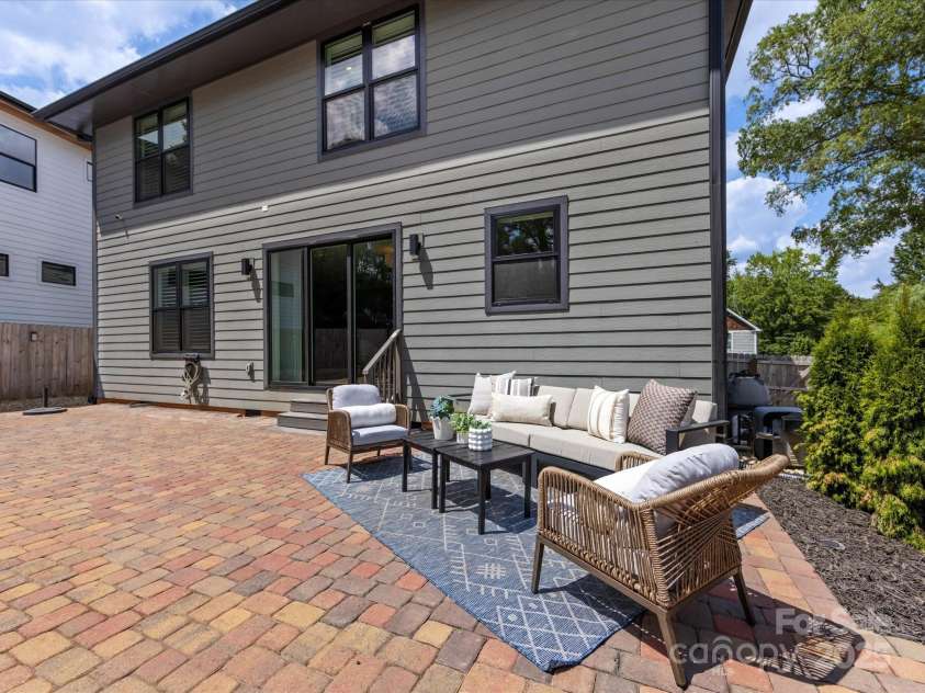 2208 Parson Street, Charlotte, NC 28205.  MLS# CAR4282025, YatesRealty ID 30926. Rear elevation of home with salt water pool and stone paver patio