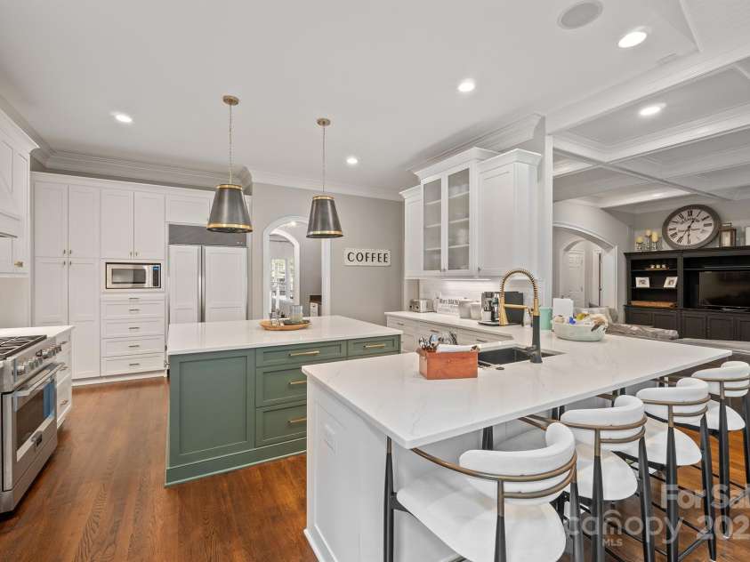 176 Old Post Road, Mooresville, NC 28117.  MLS# CAR4284694, YatesRealty ID 30932. Beautiful breakfast bar. Notice the SubZero refrigerator and built-in microwave in the background, and open floor plan into family room.