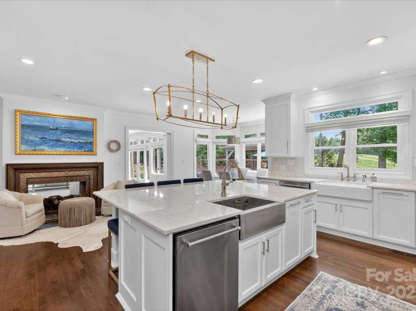 7007 Golden Rain Court, Charlotte, NC 28277.  MLS# CAR4288408, YatesRealty ID 30936. Kitchen has quartz counter top and custom cabintry and fireplace is see through to Great room