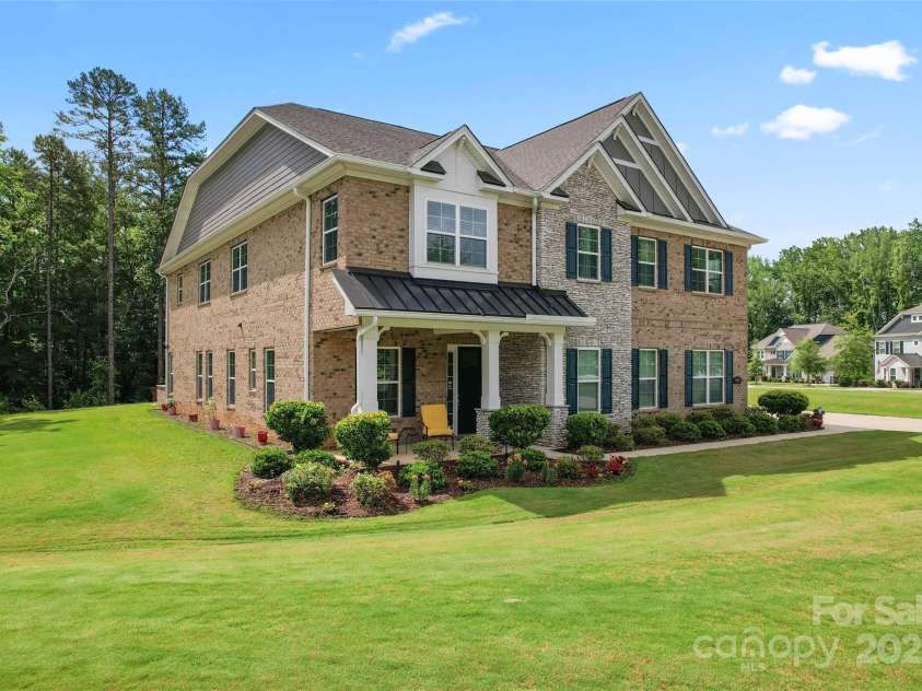 4008 Pinot Way, Fort Mill, SC 29707.  MLS# CAR4268803, YatesRealty ID 30944. One of most beautiful homes in the community, with brick, cement board, and stone exterior and triple gable elevation.