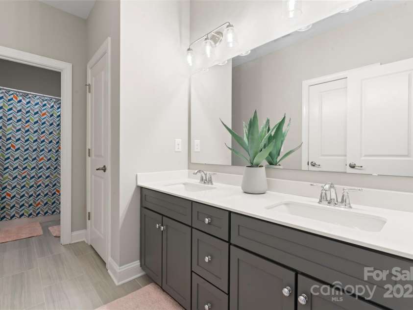 4008 Pinot Way, Fort Mill, SC 29707.  MLS# CAR4268803, YatesRealty ID 30944. Upstairs guest bathroom, with dual sinks and pristine decor.