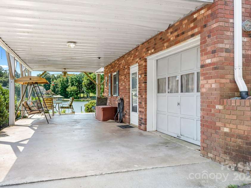 177 Brer Fox Trail, Troutman, NC 28166.  MLS# CAR4284185, YatesRealty ID 30946. Car port with access to boat garage