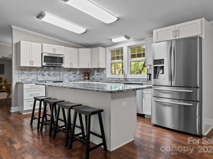 34 Edwards Street, Asheville, NC 28806.  MLS# CAR4268192, YatesRealty ID 30954. Granite countertops, island, stainless appliances and plenty of cabinet space.