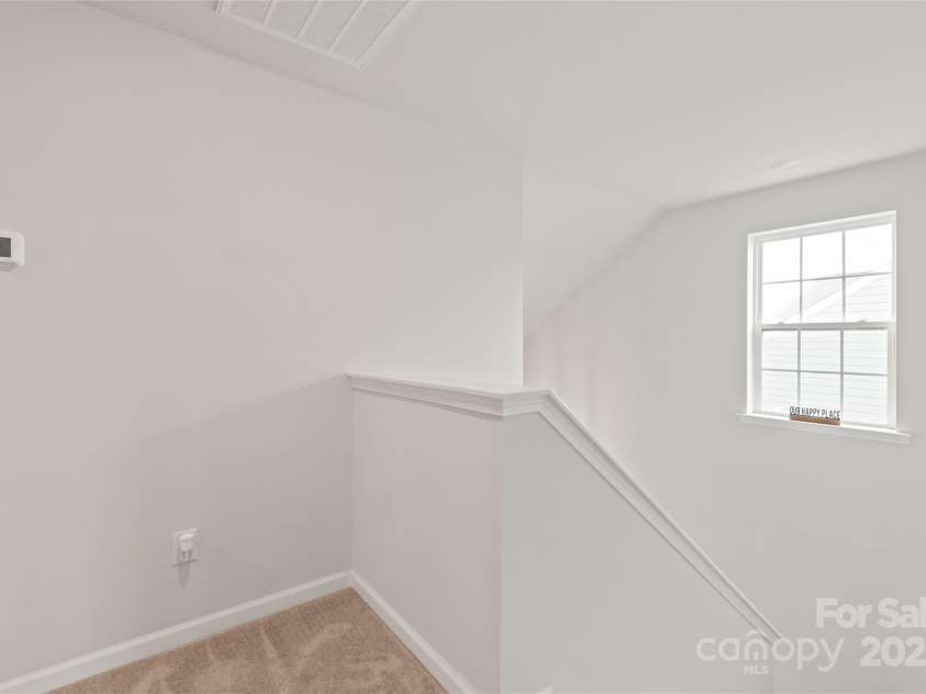 16726 Cozy Cove Road, Charlotte, NC 28278.  MLS# CAR4288880, YatesRealty ID 30958. At the top of the stairs, the spacious primary bedroom creates a quiet retreat just for you.