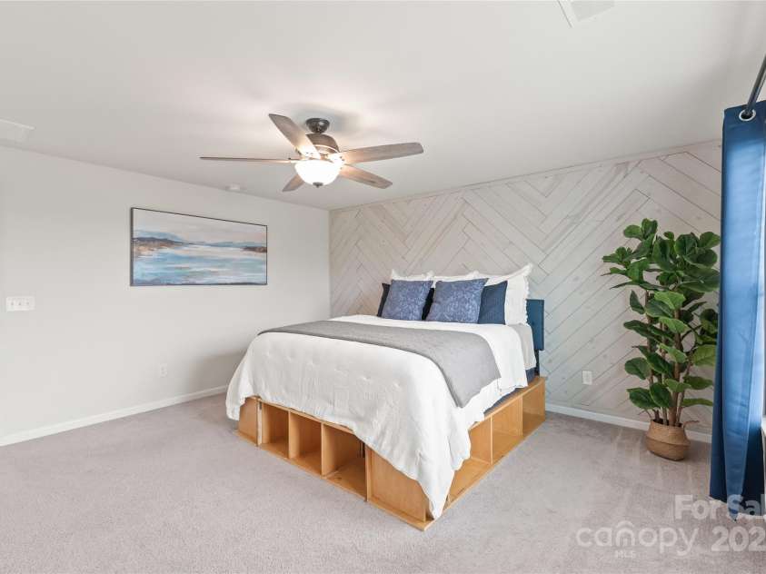 16726 Cozy Cove Road, Charlotte, NC 28278.  MLS# CAR4288880, YatesRealty ID 30958. Bright, inviting, and full of character—the primary bedroom boasts an elegant custom accent wall and a spacious ensuite.