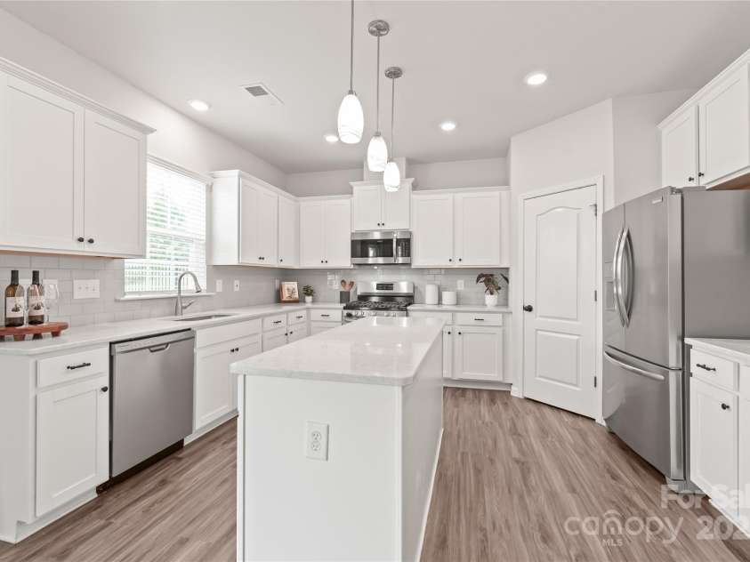 16726 Cozy Cove Road, Charlotte, NC 28278.  MLS# CAR4288880, YatesRealty ID 30958. Generous cabinet storage and stainless steel appliances, plus a fridge that conveys, mean this kitchen is ready for your next meal.