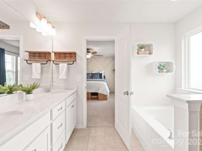 16726 Cozy Cove Road, Charlotte, NC 28278.  MLS# CAR4288880, YatesRealty ID 30958. Relax and recharge in your ensuite featuring double vanities, a garden tub, and a walk-in shower.
