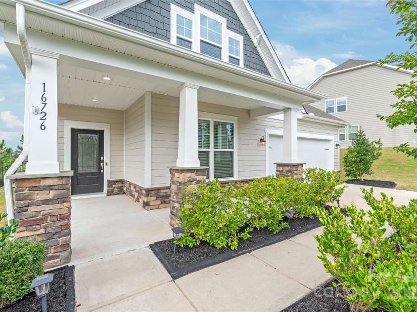 16726 Cozy Cove Road, Charlotte, NC 28278.  MLS# CAR4288880, YatesRealty ID 30958. Spacious, charming, and full of possibilities—this front porch is the kind of space that makes a house feel like home.