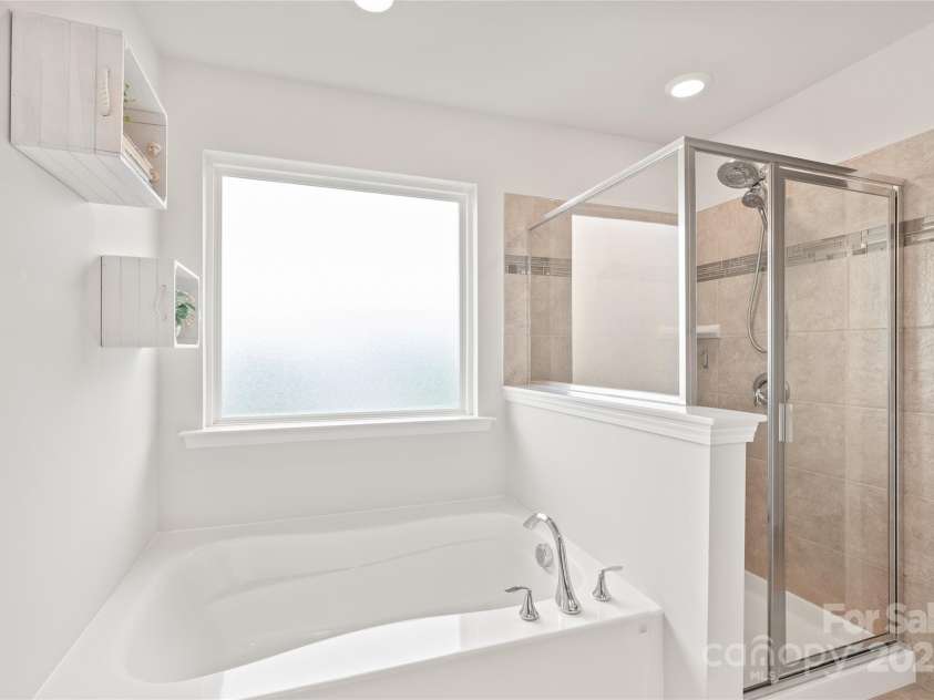 16726 Cozy Cove Road, Charlotte, NC 28278.  MLS# CAR4288880, YatesRealty ID 30958. Unwind in the garden tub or energize your day in the spacious walk-in shower—your perfect bathroom duo.