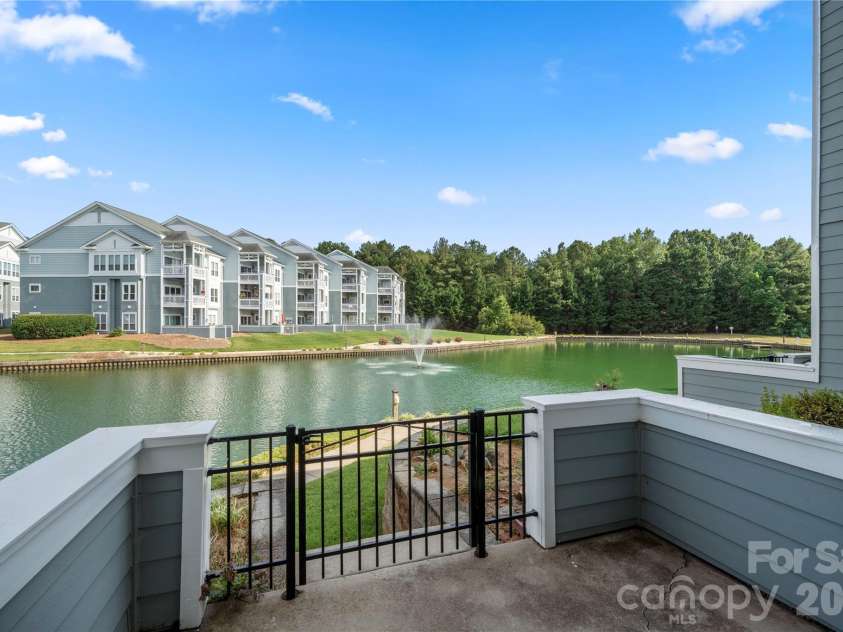 18730 Nautical Drive, Cornelius, NC 28031.  MLS# CAR4379753, YatesRealty ID 30960. Covered rear patio with pond views
