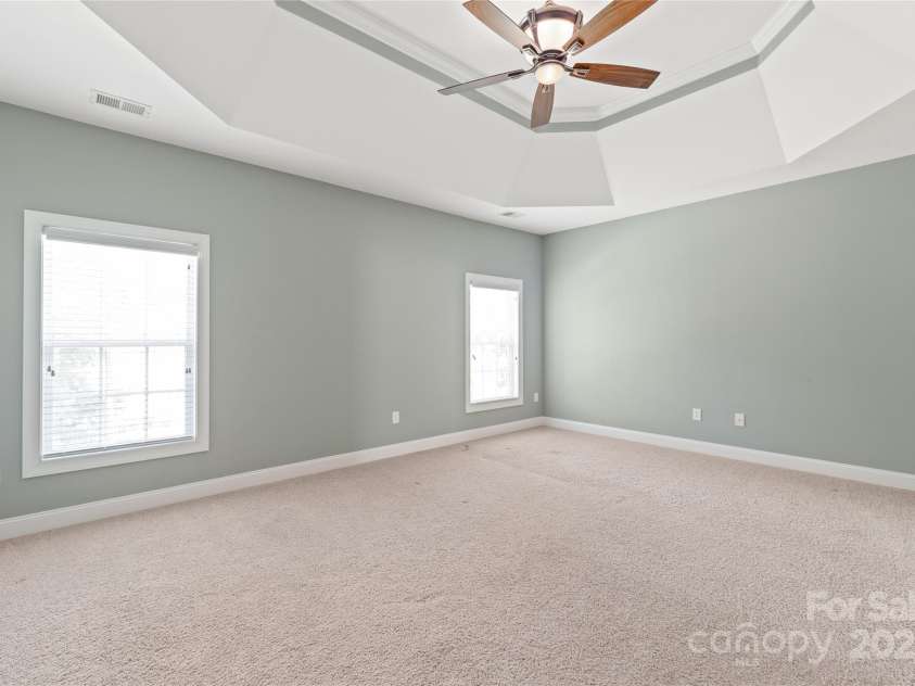 203 Vanderbilt Boulevard, Locust, NC 28097.  MLS# CAR4289783, YatesRealty ID 30966. Primary Bedroom with Tray Ceilings and Dual Closets