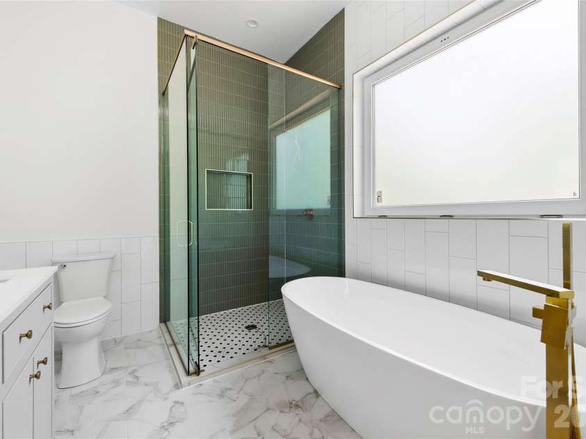 23 Early Spring Way, Leicester, NC 28748.  MLS# CAR4393952, YatesRealty ID 30974. Stylish primary bath with soaking tub 