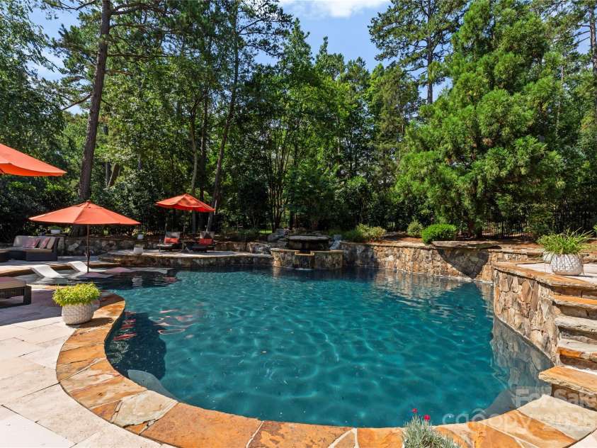 18600 River Falls Drive, Davidson, NC 28036.  MLS# CAR4231533, YatesRealty ID 30985. Enjoy the tranquil sound of water cascading from the natural stone waterfall.