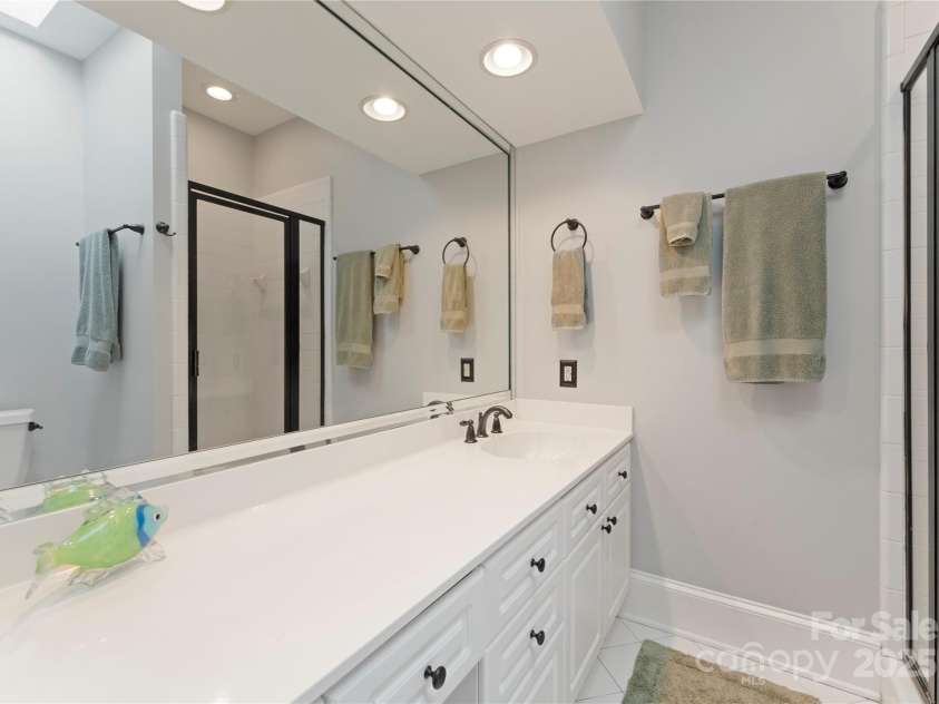 18600 River Falls Drive, Davidson, NC 28036.  MLS# CAR4231533, YatesRealty ID 30985. Ensuite bathroom has shower, a large vanity with storage, recessed lighting and skylight.
