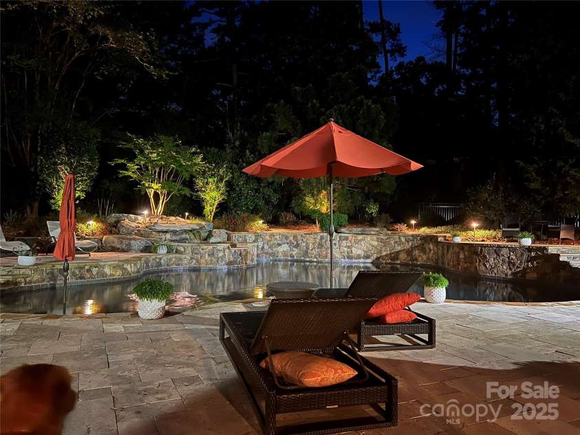 18600 River Falls Drive, Davidson, NC 28036.  MLS# CAR4231533, YatesRealty ID 30985. Pool and landscape lighting in the evening.