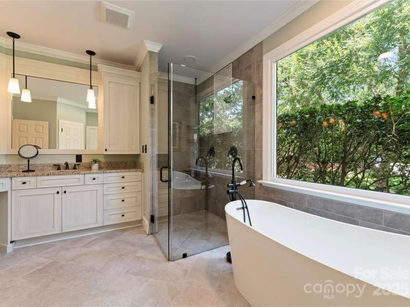 18600 River Falls Drive, Davidson, NC 28036.  MLS# CAR4231533, YatesRealty ID 30985. Updated Primary Bathroom with Frameless Shower and Free Standing Soaking Tub with handheld faucet.