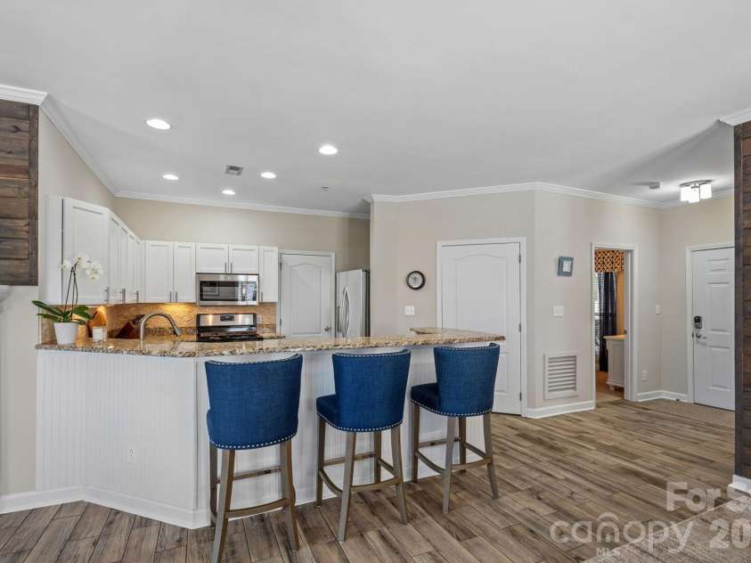 18609 Harborside Drive, Cornelius, NC 28031.  MLS# CAR4383156, YatesRealty ID 30987. Open kitchen with counter seating for casual meals or entertaining. Laundry room off kitchen features built-in shelving for pantry items.