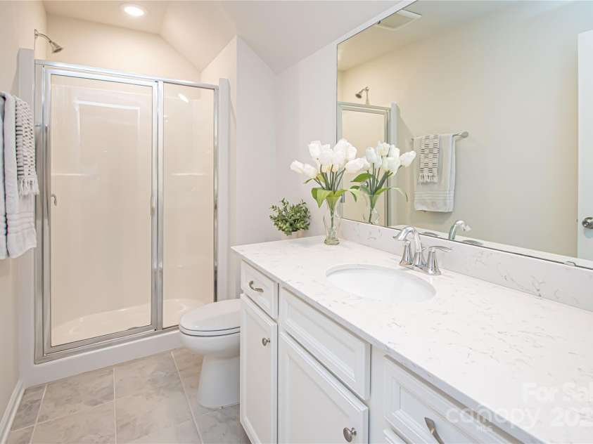 17637 Snug Harbor Road, Charlotte, NC 28278.  MLS# CAR4283392, YatesRealty ID 30990. The third-floor full bathroom features quartz countertops, tile flooring, and brushed nickel hardware and fixtures—combining style with functionality.