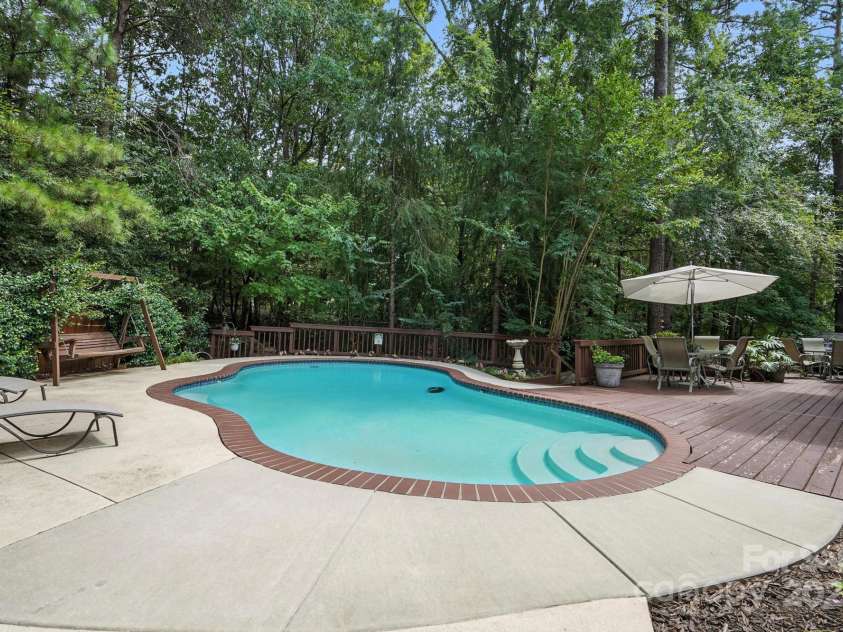 11108 Broken Brook Way, Tega Cay, SC 29708.  MLS# CAR4281529, YatesRealty ID 31004. Discover the epitome of outdoor living with this stunning in-ground gunite pool, a perfect blend of durability and design.