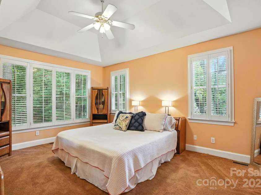 11108 Broken Brook Way, Tega Cay, SC 29708.  MLS# CAR4281529, YatesRealty ID 31004. Located on the main floor, this primary bedroom offers a blend of comfort and convenience.