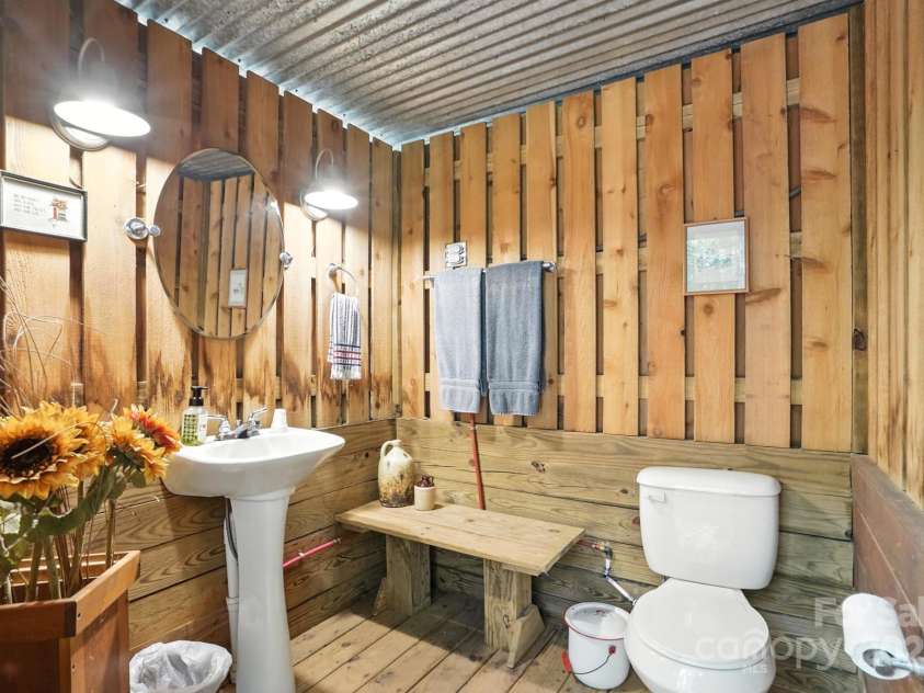 11108 Broken Brook Way, Tega Cay, SC 29708.  MLS# CAR4281529, YatesRealty ID 31004. This charming outbuilding offers a convenient and practical solution for enhancing your poolside experience. Designed with your guests' comfort in mind, it features a well-appointed half bathroom, providing a dedicat