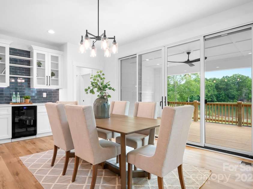 106 Arbor Drive, Waxhaw, NC 28173.  MLS# CAR4264071, YatesRealty ID 31005. Bright dining area that seamlessly connects to a spacious deck with peaceful green views — perfect for enjoying meals and relaxing.