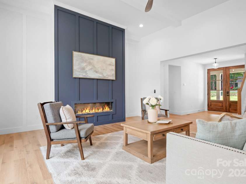 106 Arbor Drive, Waxhaw, NC 28173.  MLS# CAR4264071, YatesRealty ID 31005. Light and airy living area featuring 14-foot ceilings and a cozy modern fireplace