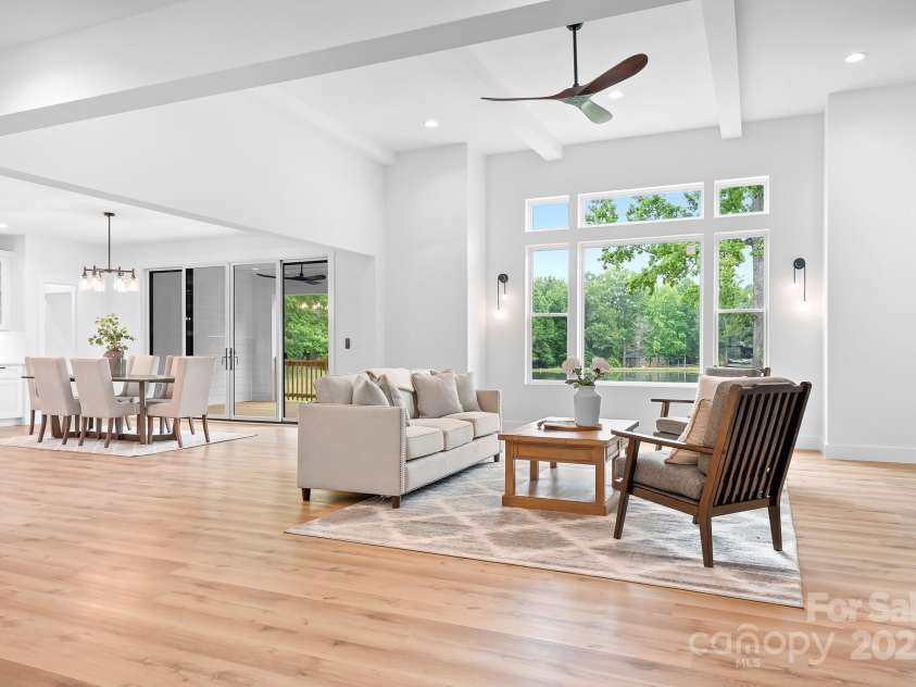 106 Arbor Drive, Waxhaw, NC 28173.  MLS# CAR4264071, YatesRealty ID 31005. Open-concept living and dining area, bathed in natural light and surrounded by peaceful green views.