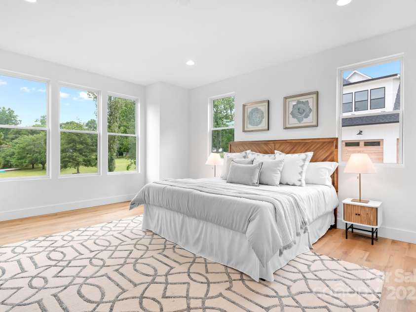 106 Arbor Drive, Waxhaw, NC 28173.  MLS# CAR4264071, YatesRealty ID 31005. Spacious and serene primary bedroom, with abundant natural light and peaceful green views to start your day right.