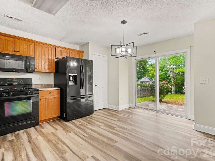 6010 Raisin Tree Lane, Charlotte, NC 28215.  MLS# CAR4394434, YatesRealty ID 31005. Kitchen- Dining Area with Patio Walk Out