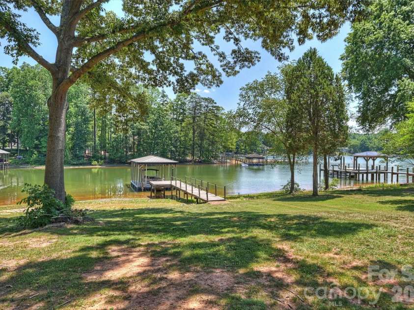 113 Skippers Cove Lane, Troutman, NC 28166.  MLS# CAR4393829, YatesRealty ID 31018. Backyard and Pier